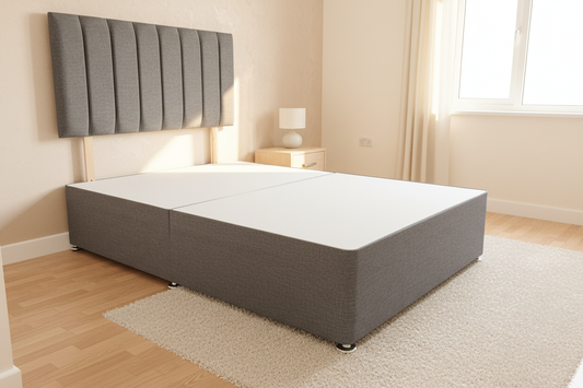 Dark grey divan bed in bedroom setting without mattress